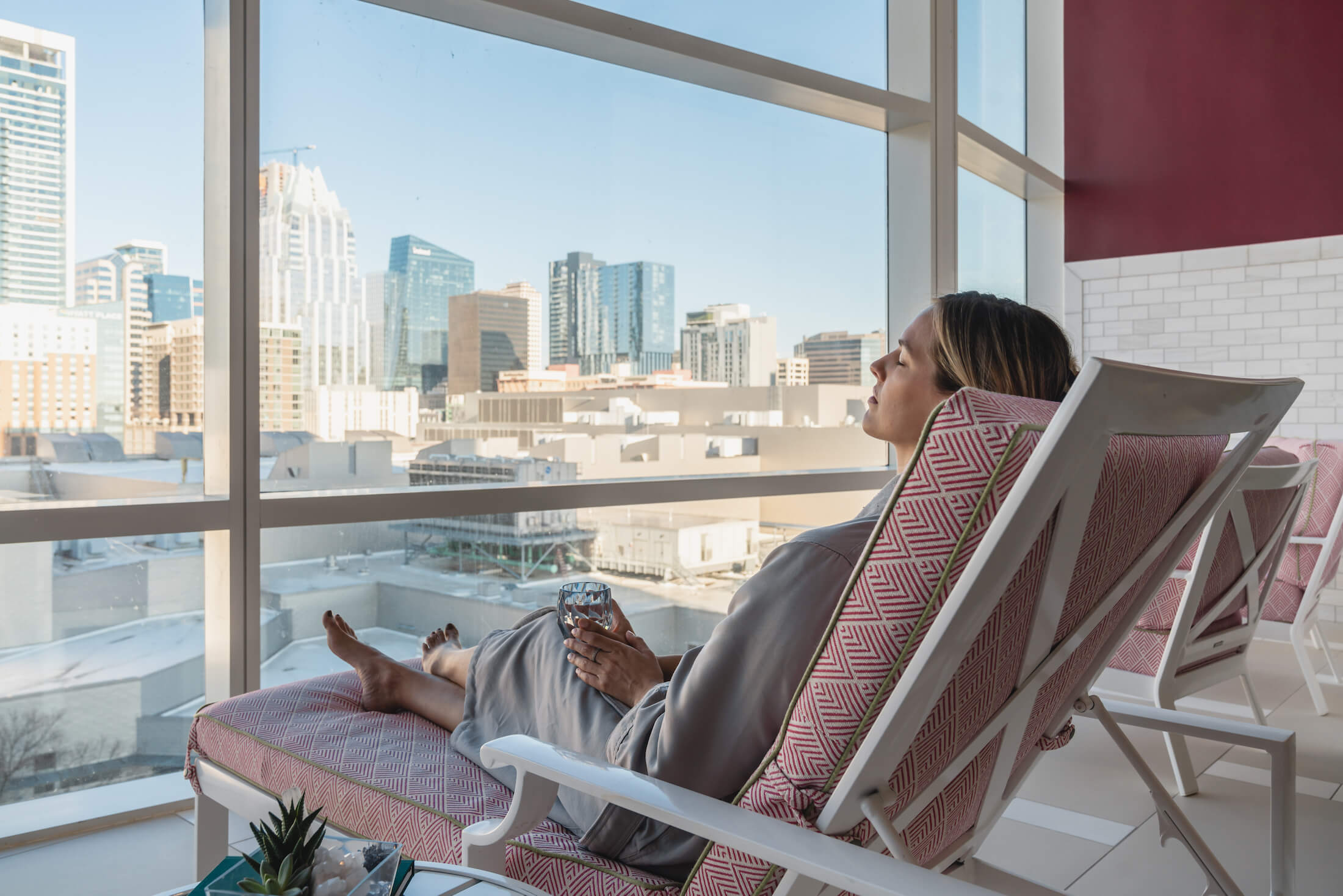 Woman lounging beside window in spa