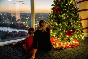 family sitting by christmas tree