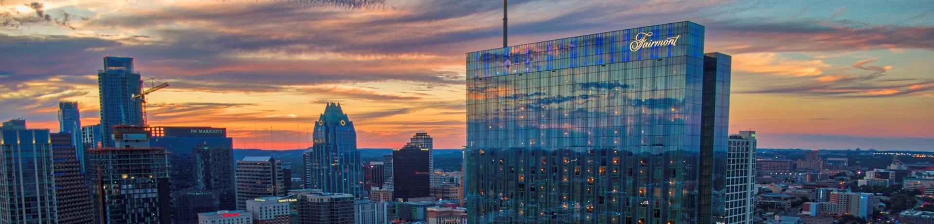 exterior photo of fairmont austin in the texas sunset