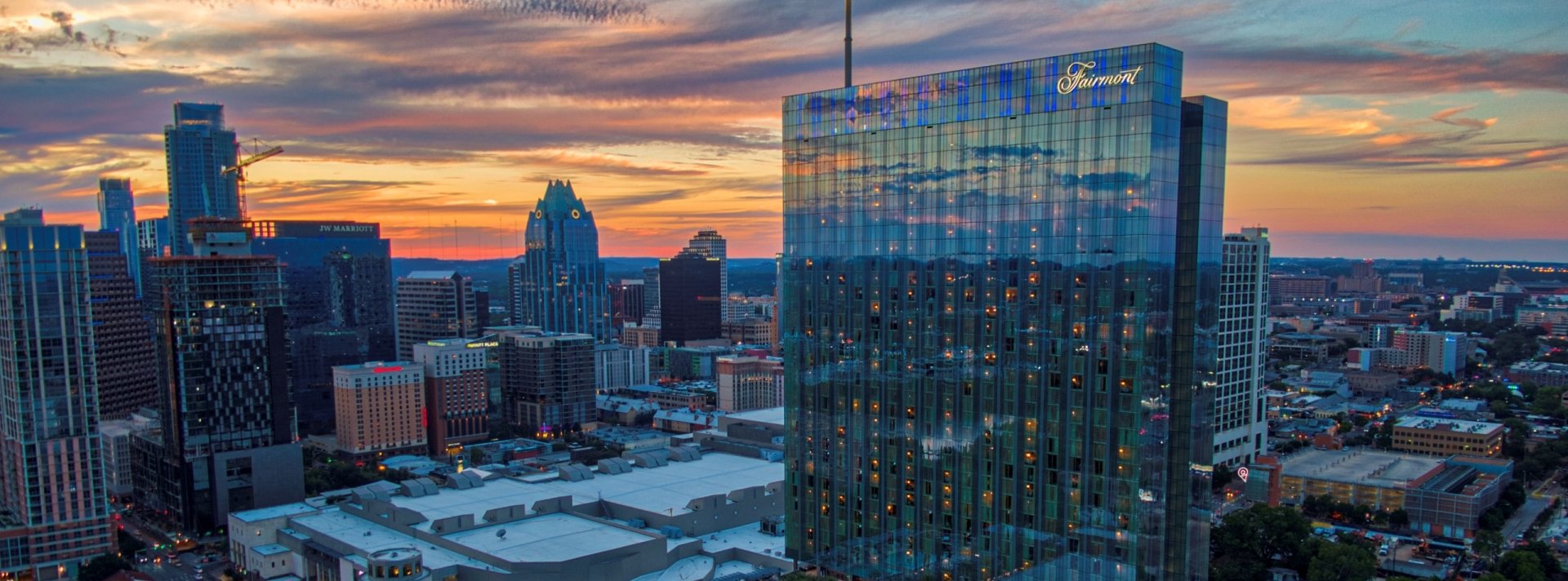 exterior photo of fairmont austin in the texas sunset