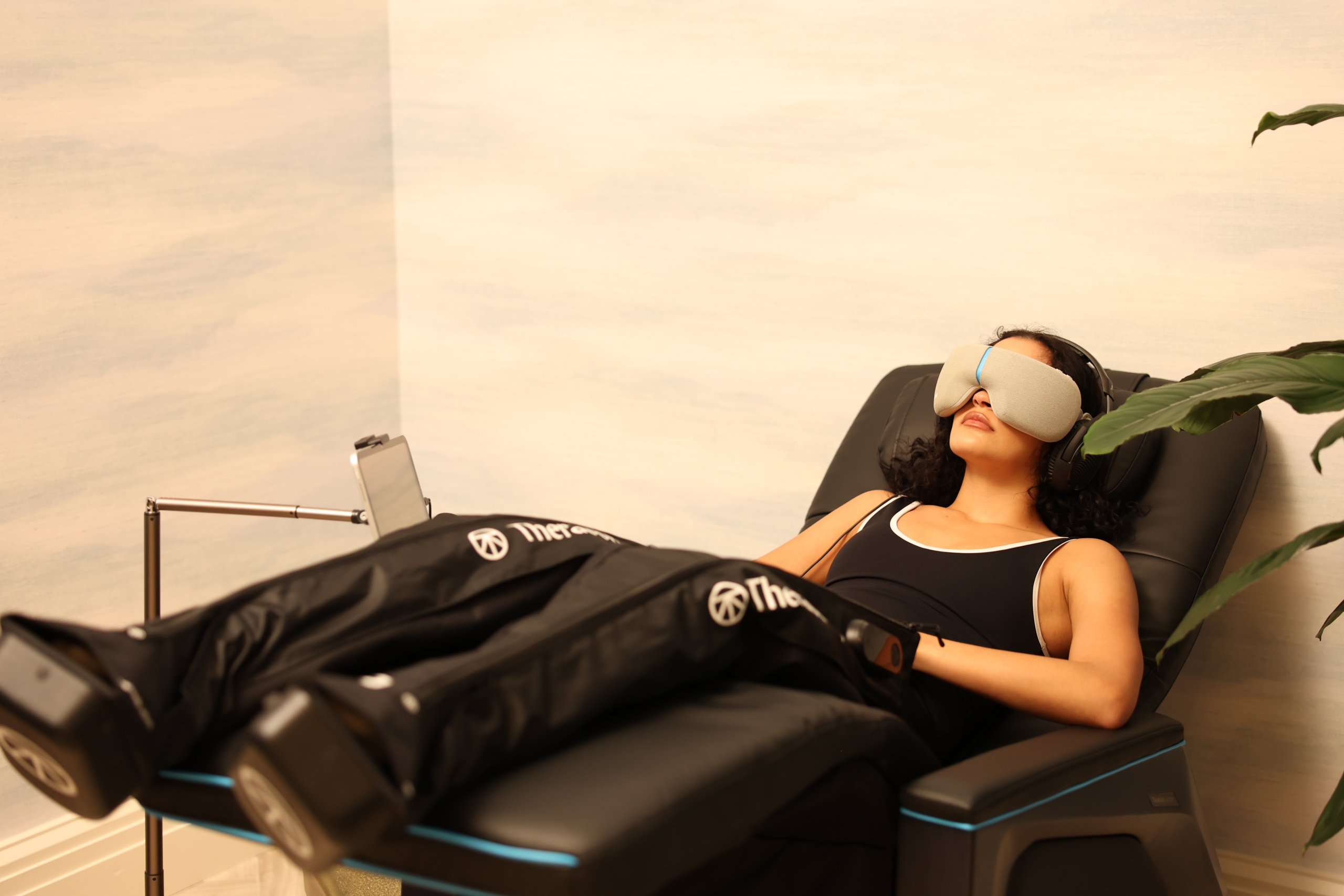 women relaxing in Therabody lounger